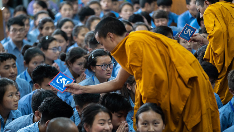 Các vị trợ giúp Nghi lễ đang di chuyển giữa các khán giả với Pháp khí gia trì khi Thánh Đức Đạt Lai Lạt Ma ban lễ Gia trì Đức Bạch Văn Thù vào ngày cuối cùng của Pháp hội dành cho Thanh thiếu niên học sinh Tây Tạng tại Chùa Tây Tạng Chính ở Dharamsala, Ấn Độ vào 8 tháng 6, 2018. Ảnh Tenzin Choejor