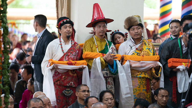 Các thành viên của cộng đồng Tây Tạng trong trang phục truyền thống của ba tỉnh Tây Tạng đang mang những phẩm vật cúng dường trong buổi Lễ cúng dường Trường thọ dâng lên Thánh Đức Đạt Lai Lạt Ma tại Chùa Tây Tạng Chính ở Dharamsala, HP, Ấn Độ vào 17 tháng 5, 2019. Ảnh của Tenzin Choejor